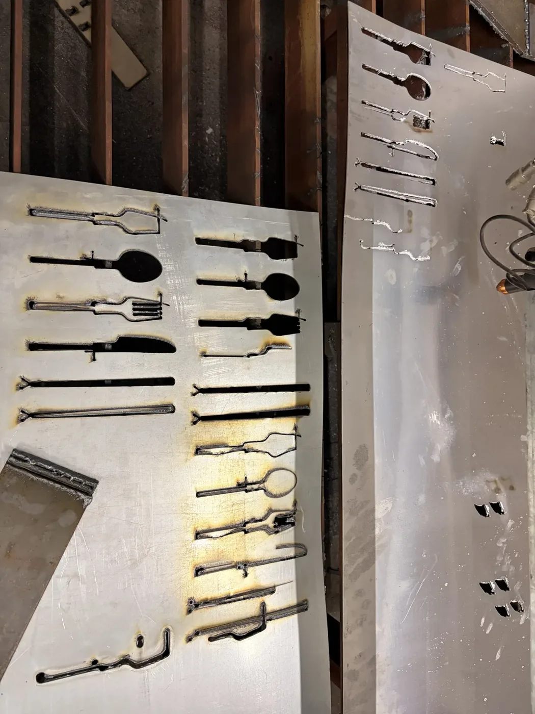 Laser-cut sheet with cutlery outlines