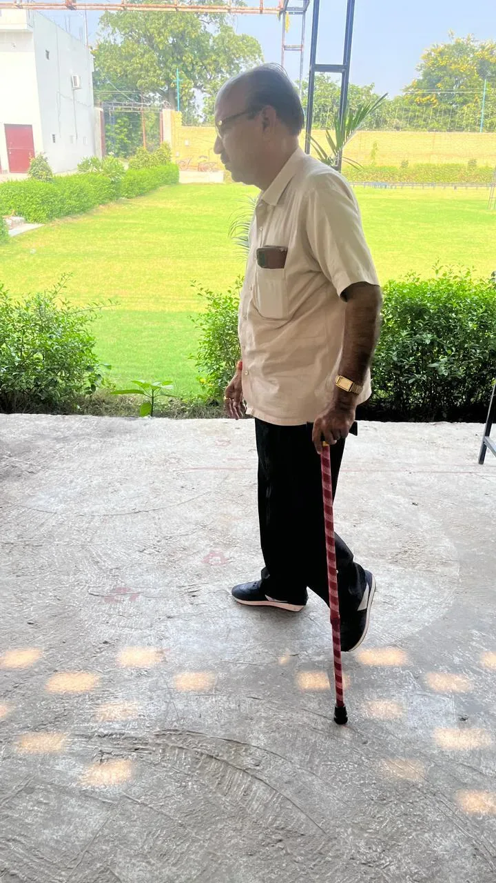 Elderly man walking with a cane