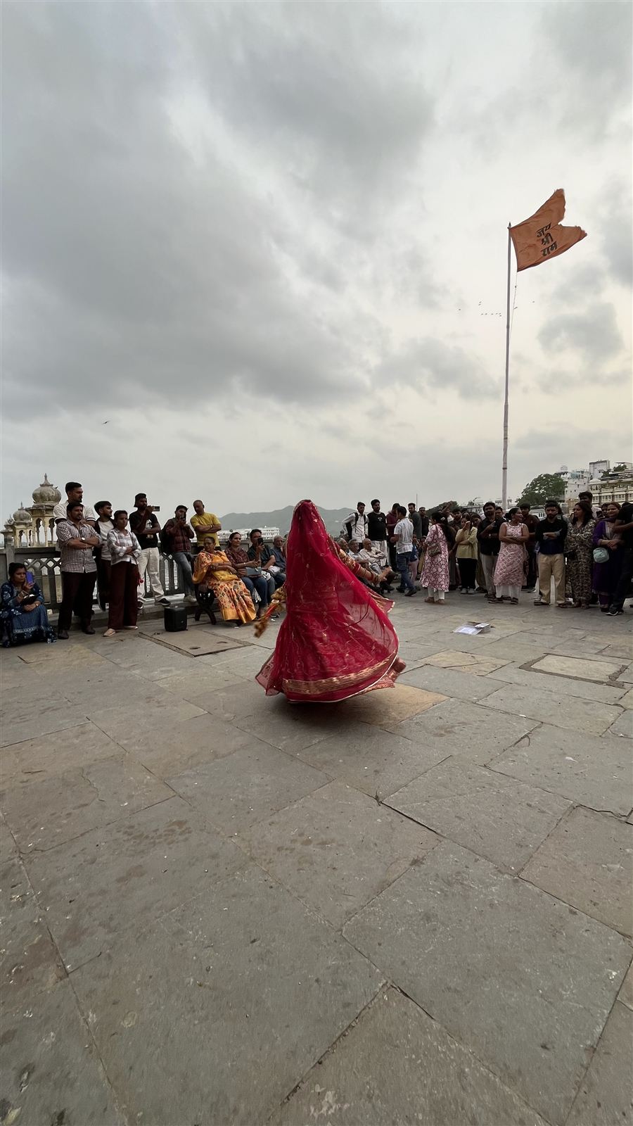 Woman in a red dress dancing for a crowd