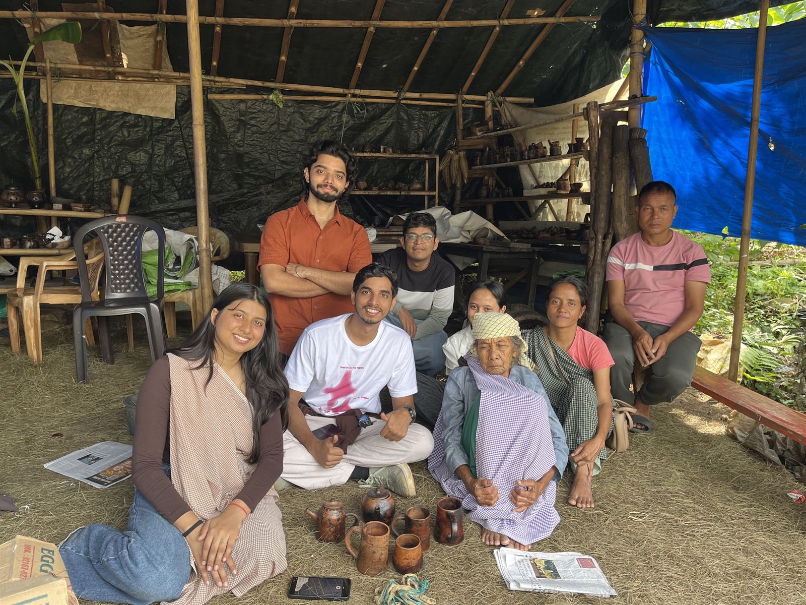 Group of students sitting with villagers