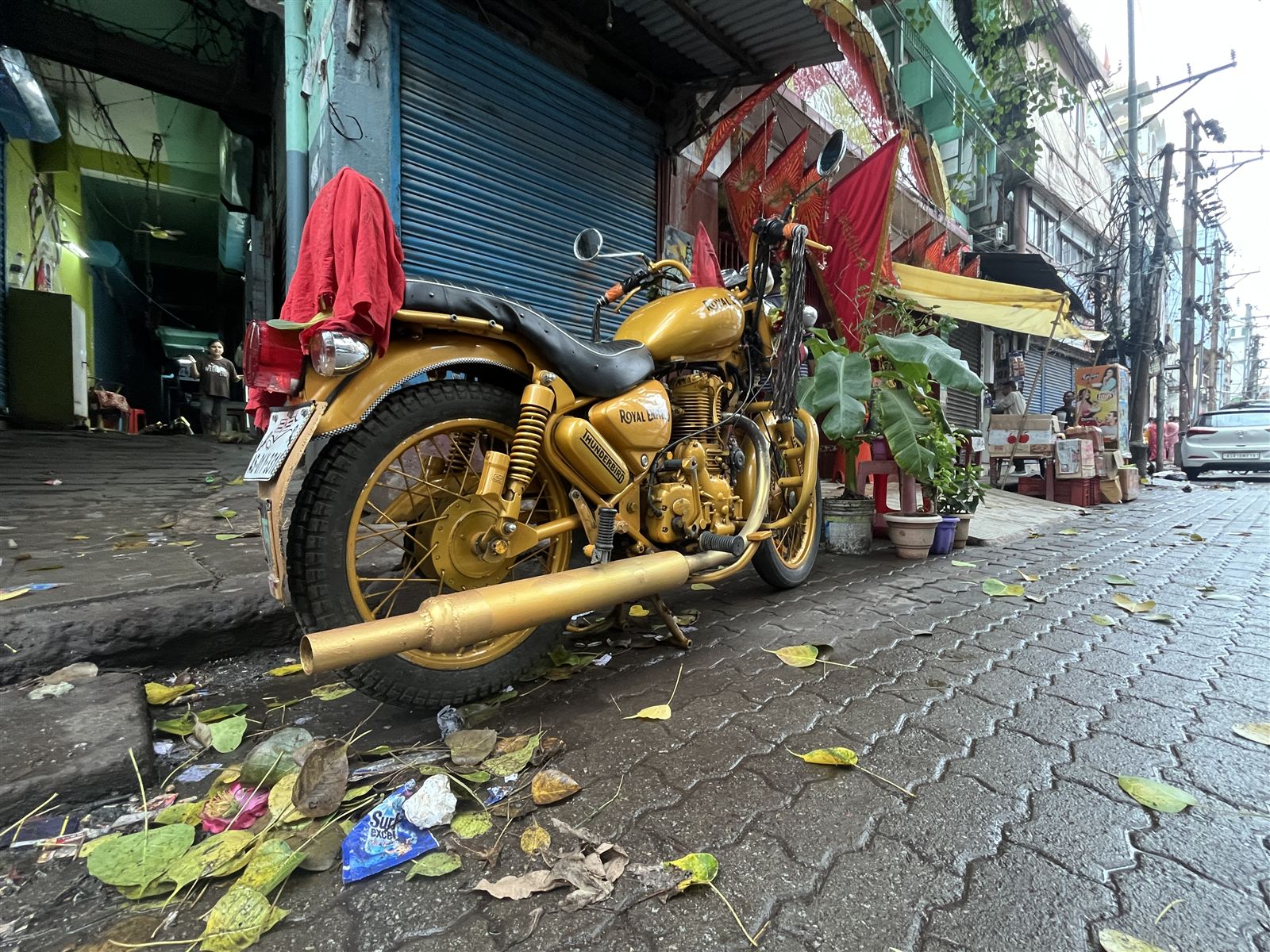 Gold motorbike parked on a market street